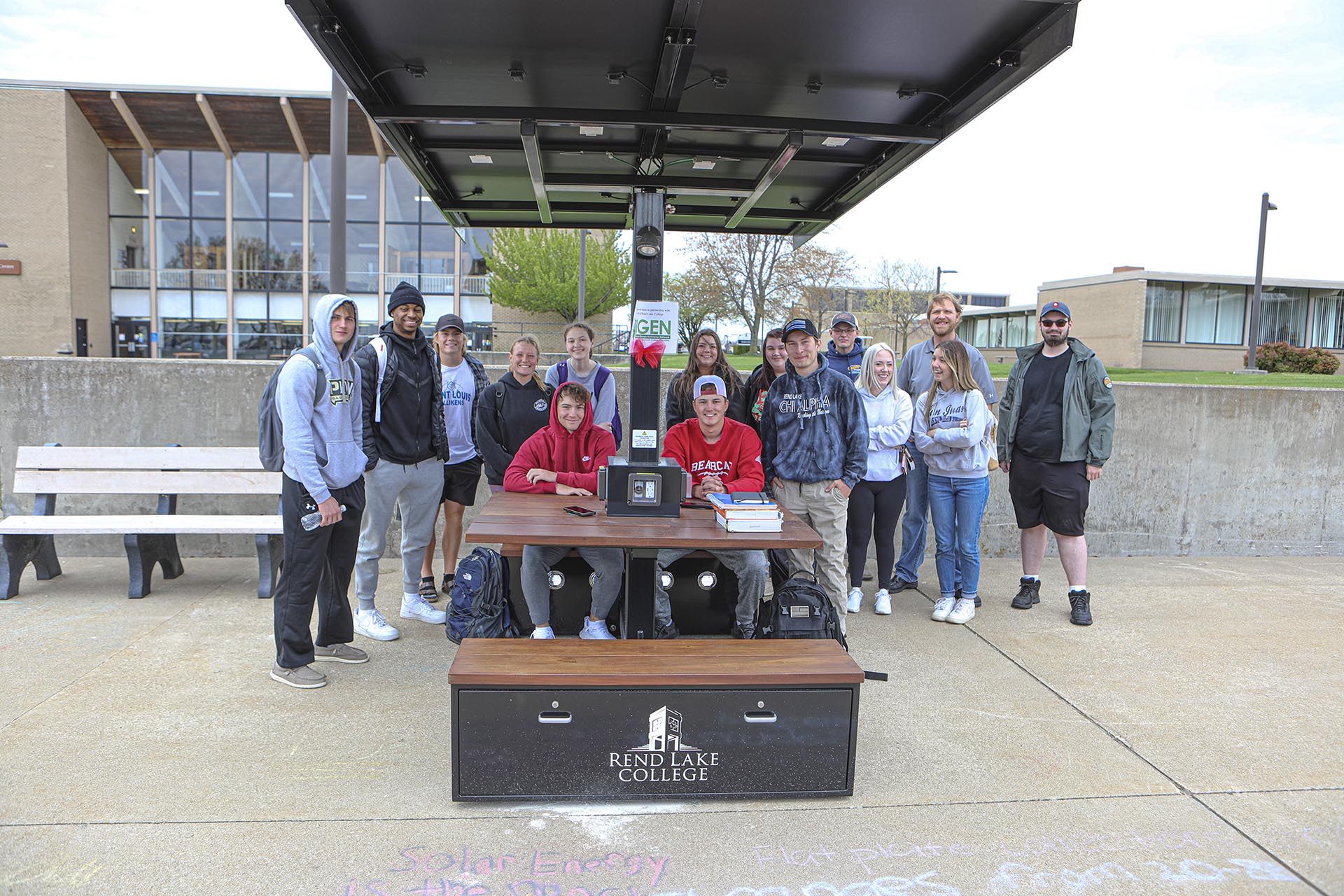 Rend Lake College students gathered beneath a solar charging station