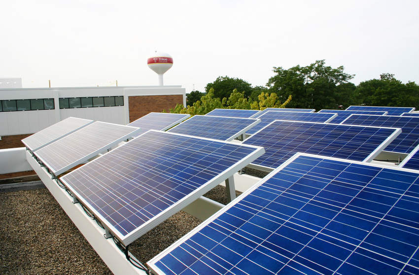 Photo of roof top solar panels at Triton college with water tower in the background