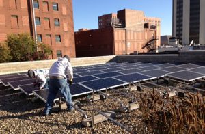 Photo of students installing solar panels on a roof top at City Colleges of Chicago